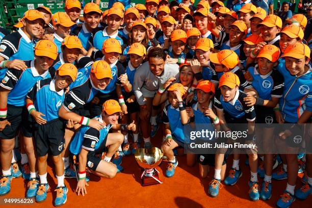 Rafael Nadal of Spain poses his winners trophy and the ball kids after winning the Monte Carlo Rolex Masters against Kei Nishikori of Japan during...