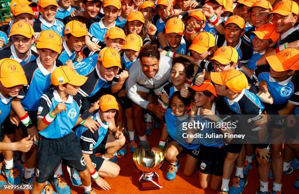 Rafael Nadal of Spain poses his winners trophy and the ball kids after winning the Monte Carlo Rolex Masters against Kei Nishikori of Japan during...