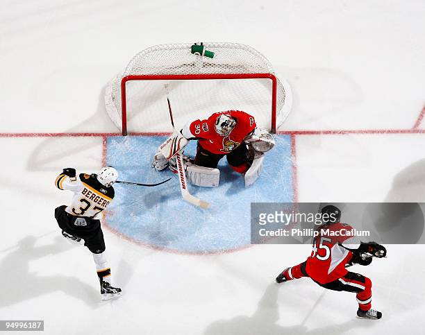 Patrice Bergeron of the Boston Bruins shoots the puck past Brian Elliott of the Ottawa Senators in a game at Scotiabank Place on December 21, 2009 in...