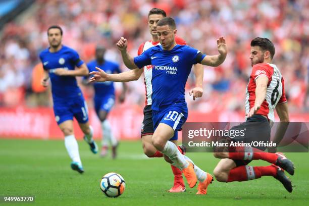 Eden Hazard of Chelsea in action with Wesley Hoedt and Dusan Tadic of Southampton during the Emirates FA Cup Semi Final between Chelsea and...