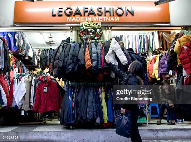 Shopper browses clothing on display at a shop in Hanoi, Vietnam, on Saturday, Dec. 19, 2009. Vietnam's fourth-quarter GDP figures will be released on...