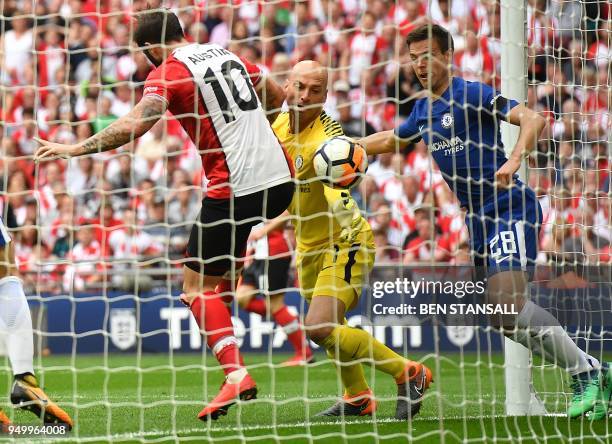 Southampton's English striker Charlie Austin fouls Chelsea's Argentinian goalkeeper Willy Caballero during the English FA Cup semi-final football...