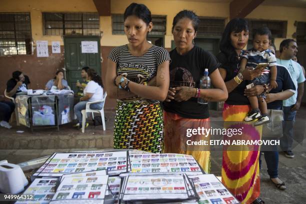 Indigenous women of the Maka tribe prepare to vote at a polling station in Mariano Roque Alonso, outskirts of Asuncion on April 22 during Paraguay's...