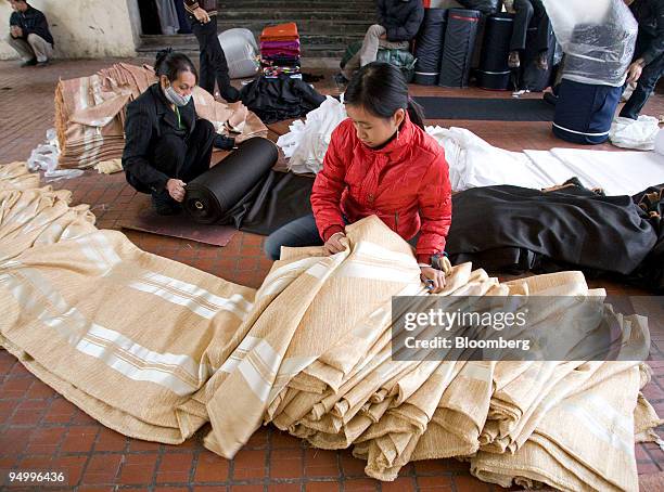 Women measure fabric at a market in Hanoi, Vietnam, on Monday, Dec. 21, 2009. Vietnam's fourth-quarter GDP figures will be released on or after Dec....