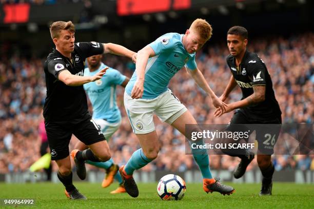 Manchester City's Belgian midfielder Kevin De Bruyne takes on Swansea City's English midfielder Tom Carroll during the English Premier League...