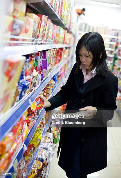 Shopper selects crackers at a supermarket in Hanoi, Vietnam, on Monday, Dec. 21, 2009. Vietnam's fourth-quarter GDP figures will be released on or...