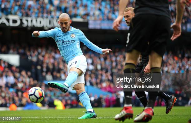 David Silva of Manchester City scores his side's first goal during the Premier League match between Manchester City and Swansea City at Etihad...
