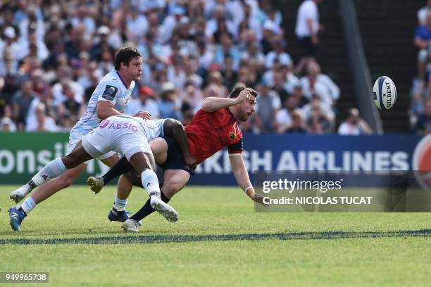 Munster's Irish fly-half JJ Hanrahan is tackled during the European Champions Cup semi-final rugby union match between Racing 92 and Munster on April...