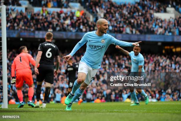 David Silva of Manchester City celebrates scoring his side's first goal during the Premier League match between Manchester City and Swansea City at...