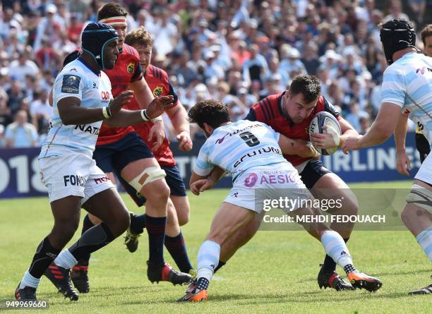 Munster's Irish centre Niall Scannell is tackled by Racing 92's French scrum-half Maxime Machenaud during the European Champions Cup semi-final rugby...