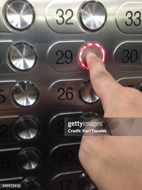 pressing an elevator button - pressing elevator button stock pictures, royalty-free photos & images