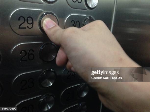 pressing an elevator button - pressing elevator button stock pictures, royalty-free photos & images