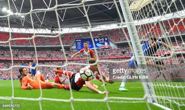 Chelsea's French striker Olivier Giroud watvhes the ball into the net as he scores his team's first goal during the English FA Cup semi-final...