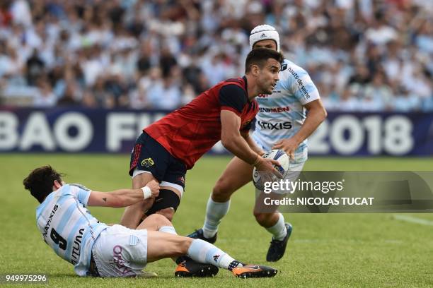 Munster's Irish scrum-half Conor Murray is tackled by Racing 92's French scrum-half Maxime Machenaud during the European Champions Cup semi-final...