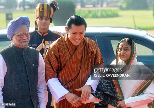 King of Bhutan, Jigme Khesar Namgyel Wangchuck greets Indian President Prathiba Singh Patil as Indian Prime Minister Manmohan Singh looks on during a...