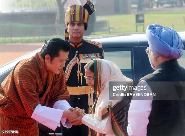 King of Bhutan, Jigme Khesar Namgyel Wangchuck greets Indian President Prathiba Singh Patil as Indian Prime Minister Manmohan Singh looks on during a...