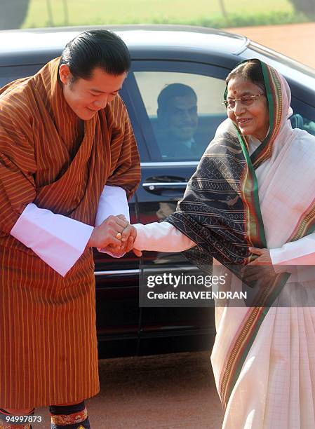 King of Bhutan, Jigme Khesar Namgyel Wangchuck greets Indian President Prathiba Singh Patil during a welcome ceremony at the Presidential Palace in...