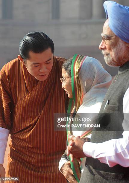 King of Bhutan, Jigme Khesar Namgyel Wangchuck talks with Indian President Prathiba Singh Patil as Indian Prime Minister Manmohan Singh looks on...