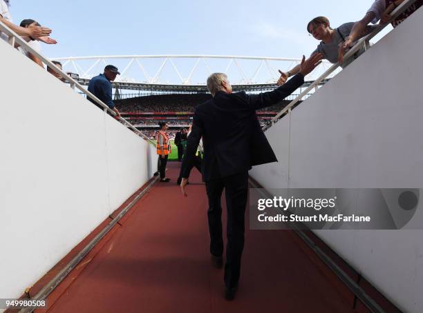 Arsenal manager Arsene Wenger walks to the pitch before the Premier League match between Arsenal and West Ham United at Emirates Stadium on April 22,...