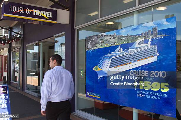 Pedestrian walks past advertisements posted outside the House of Travel agency in the suburb of Parnell in Auckland, New Zealand, on Tuesday, Dec....