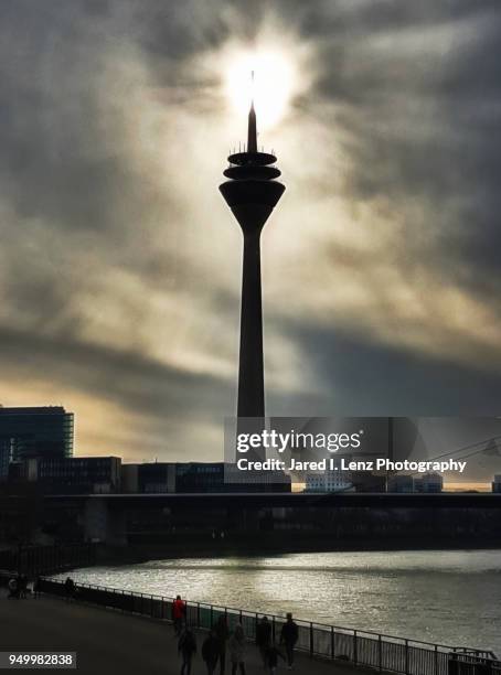 a burst of light at the top of the rhine tower - glow düsseldorf stock-fotos und bilder