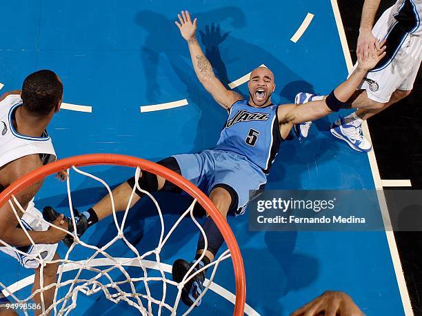 Carlos Boozer of the Utah Jazz reacts after landing on his back during the game against the Orlando Magic on December 21, 2009 at Amway Arena in...