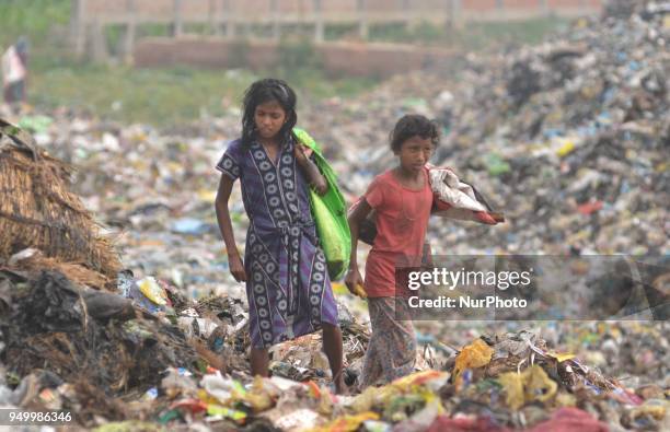 Young Indian rag picker search among piles of garbage at a dumping site on World Earth Day in Dimapur, India north eastern state of Nagaland on...