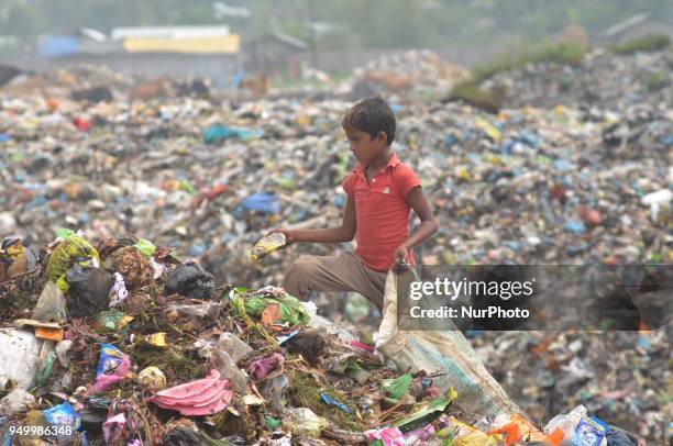 Young Indian rag picker search among piles of garbage at a dumping site on World Earth Day in Dimapur, India north eastern state of Nagaland on...