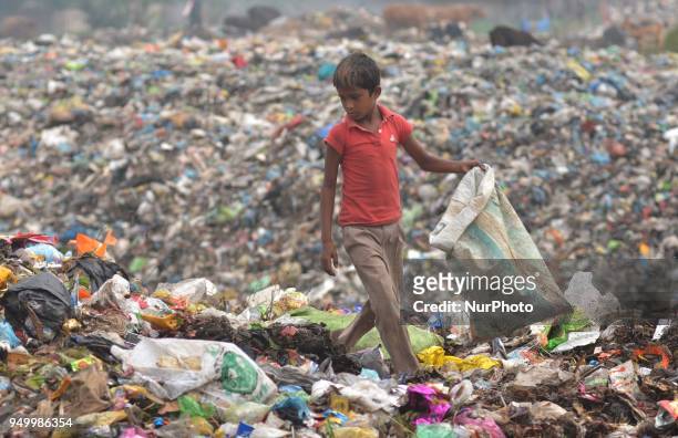 Young Indian rag picker search among piles of garbage at a dumping site on World Earth Day in Dimapur, India north eastern state of Nagaland on...