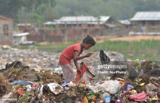 Young Indian rag picker search among piles of garbage at a dumping site on World Earth Day in Dimapur, India north eastern state of Nagaland on...