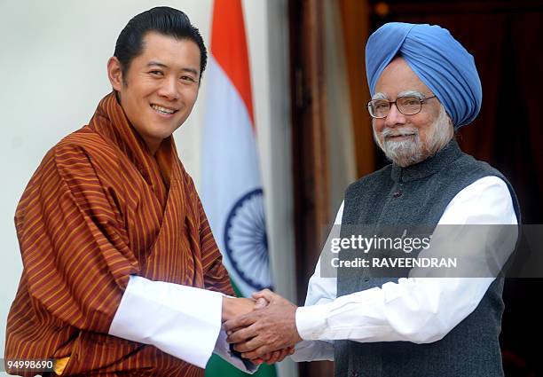 King of Bhutan, Jigme Khesar Namgyel Wangchuck shakes hands with Indian Prime Minister Manmohan Singh during a meeting in New Delhi on December 22,...
