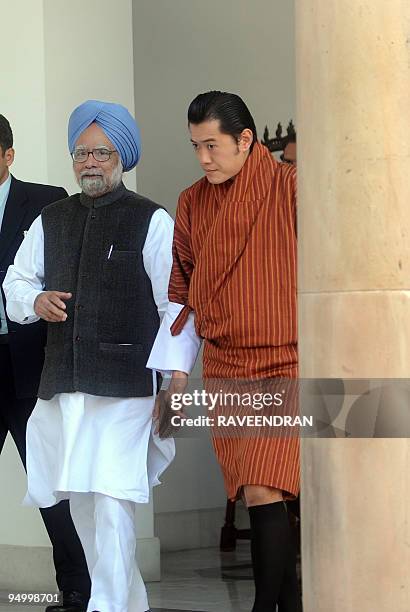 King of Bhutan, Jigme Khesar Namgyel Wangchuck walks with Indian Prime Minister Manmohan Singh at a meeting in New Delhi on December 22, 2009....