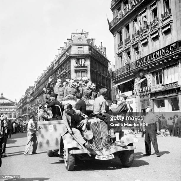 Soldiers and a policeman on Avenue de l'Opera, leading German officers and soldiers to Police Headquarters on August 5 after the takeover of the...