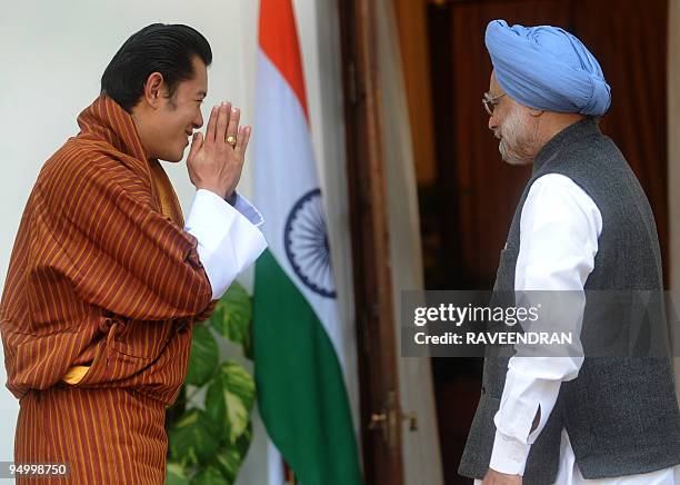 King of Bhutan, Jigme Khesar Namgyel Wangchuck greets Indian Prime Minister Manmohan Singh at a meeting in New Delhi on December 22, 2009. Wangchuck...