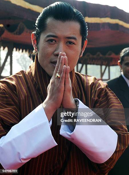 King of Bhutan, Jigme Khesar Namgyel Wangchuck makes a traditional greeting on his arrival at the Presidential Palace in New Delhi on December 22,...