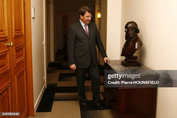 French minister for Education, Xavier Darcos, at the Minister for Education in Paris. He is looking at a Jules Ferry bust.