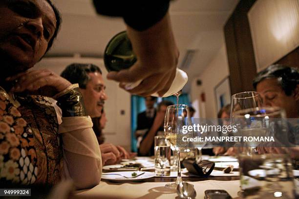 In this file photograph taken on May 8 members of the Delhi Wine Club are served wine during a dinner organised by the club in New Delhi. Two Italian...