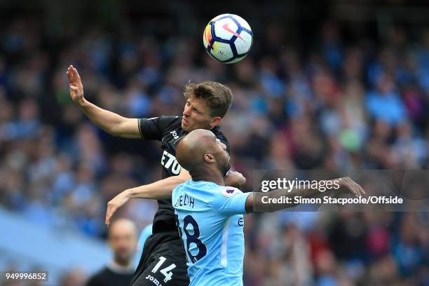 Tom Carroll of Swansea battles with Fabian Delph of Man City during the Premier League match between Manchester City and Swansea City at the Etihad...
