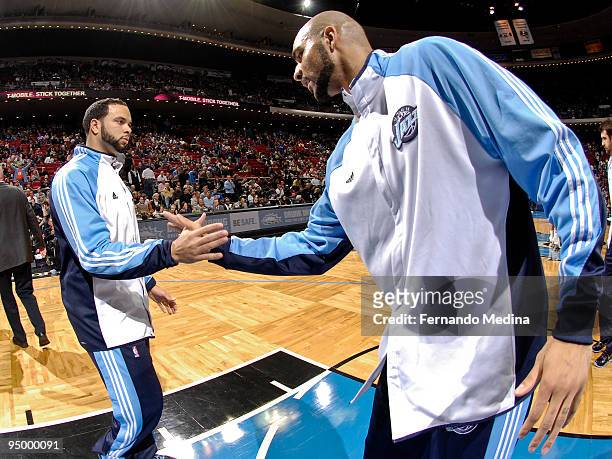 Deron Williams and Carlos Boozer of the Utah Jazz shake hands during player introductions before the game against the Orlando Magic on December 21,...