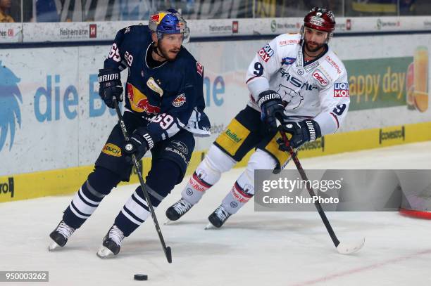 Danny Richmond of Eisbaeren Berlin vies Florian Kettemer of Red Bull Munich during the DEL Playoff final match five between EHC Red Bull Munich and...