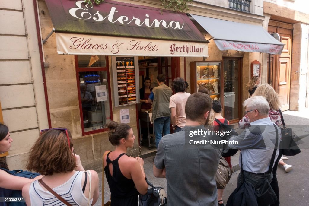 People enjoy the sun and warm spring temperatures in Paris