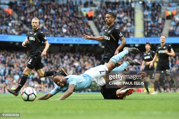 Swansea City's Argentinian defender Federico Fernandez fouls Manchester City's English midfielder Raheem Sterling to concede a penalty during the...