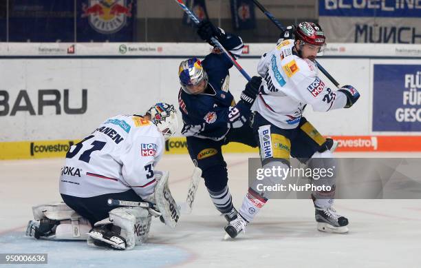 Thomas Oppenheimer of Eisbaeren Berlin vies Mads Christensen of Red Bull Munich in front of Petri Vehanen of Eisbaeren Berlin during the DEL Playoff...