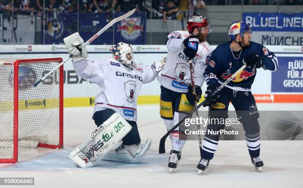 Andre Rankel of Eisbaeren Berlin vies Frank Mauer of Red Bull Munich in front of Petri Vehanen of Eisbaeren Berlin during the DEL Playoff final match...