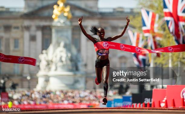 Vivian Cheruiyot of Kenya celebrates after crossing the finish line to win the elite women's race during the Virgin Money London Marathon at United...