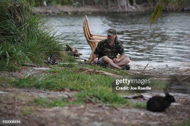 Volunteer with East Coast Rabbit Rescue uses a net to capture a rabbit near Pioneer Canal Park on April 22, 2018 in Boynton Beach, Florida. The...