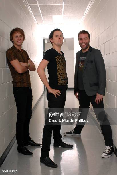 Dominic Howard, Matt Bellamy and Chris Wolstenholme of Muse pose for a group portrait backstage at the Rod Laver Arena on November 15th 2007 in...