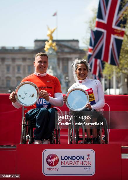 David Weir of Great Britain and Madison de Rozario of Australia pose as they receive their trophies, following their first place results during the...