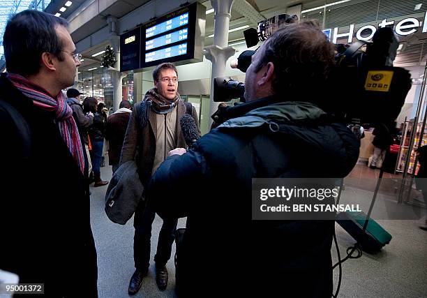 Eurostar passenger speaks to the media at Kings Cross St Pancras train station in London, after arriving on train from Brussels, on December 22,...