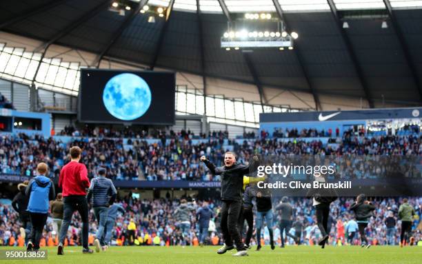 Fans invade the pitch following the Premier League match between Manchester City and Swansea City at Etihad Stadium on April 22, 2018 in Manchester,...